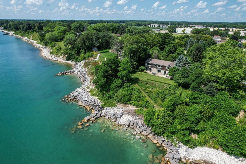 Nestled on almost 2 acres on the shores of Lake Michigan this - Beach Home for sale in Mount Pleasant, Wisconsin on Beachhouse.com