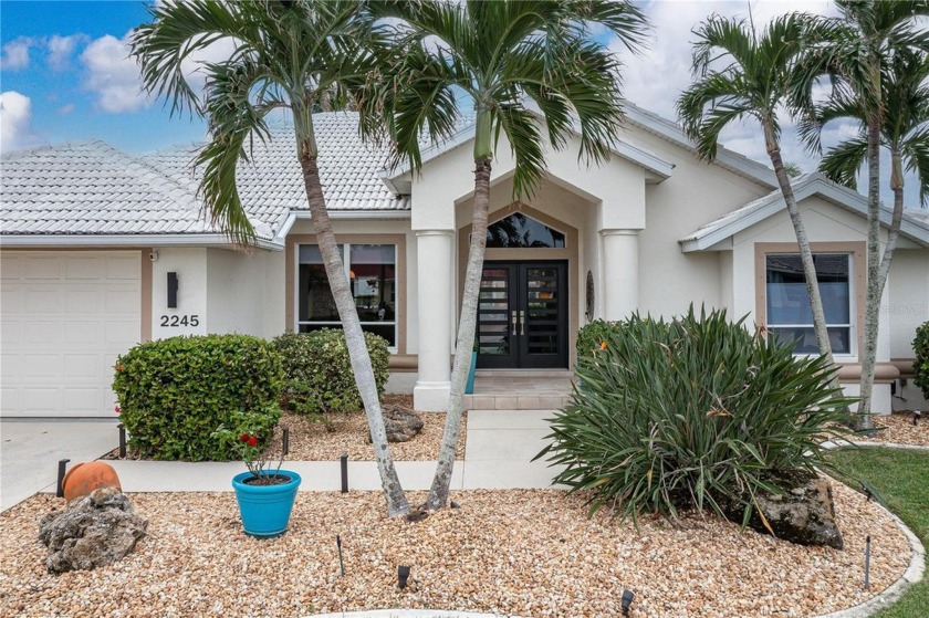 CONTEMPORARY WATERFRONT HOME IN PGI W/SOUTHERN REAR EXPOSURE - Beach Home for sale in Punta Gorda, Florida on Beachhouse.com