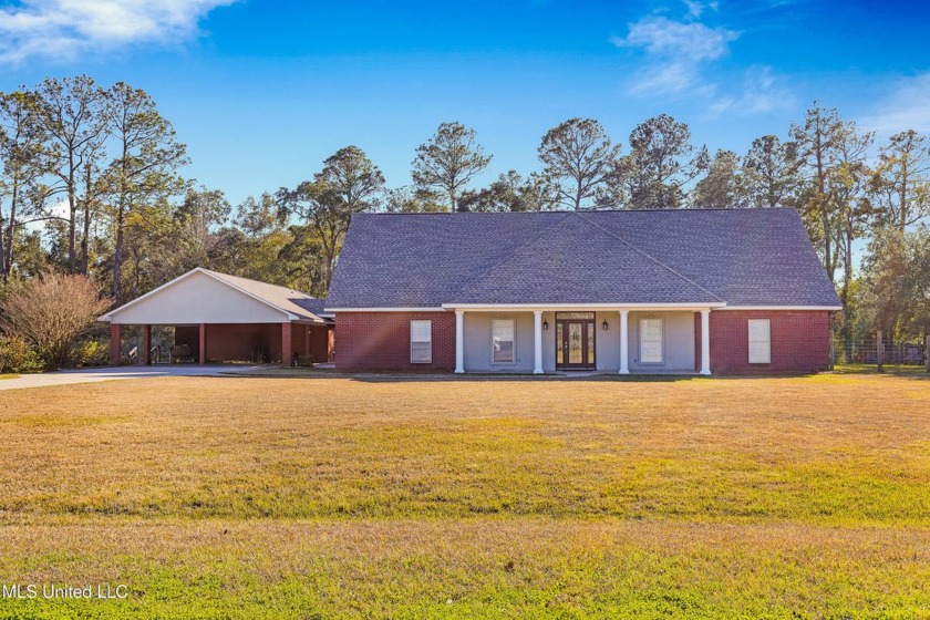 Tucked away on a private half-acre lot down a long gravel drive - Beach Home for sale in Long Beach, Mississippi on Beachhouse.com