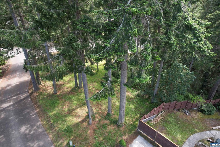 Tucked among towering evergreens in the desirable Woodland - Beach Lot for sale in Sequim, Washington on Beachhouse.com