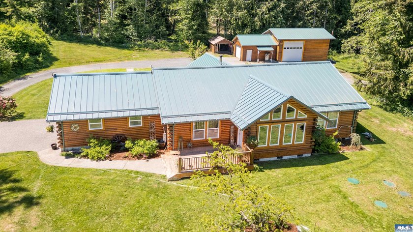 Tucked away on 4.7 beautiful acres, this stunning log home - Beach Home for sale in Port Angeles, Washington on Beachhouse.com