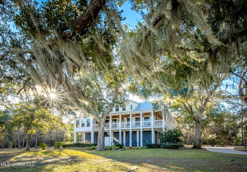 Nestled under a canopy of majestic live oaks, this breathtaking - Beach Home for sale in Ocean Springs, Mississippi on Beachhouse.com