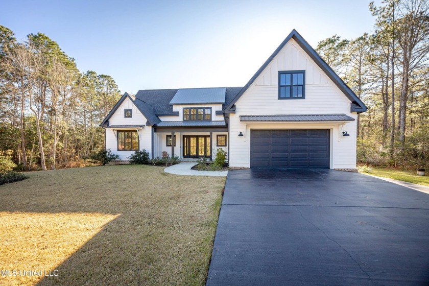 Nestled in a prestigious gated golf course community, this - Beach Home for sale in Gautier, Mississippi on Beachhouse.com