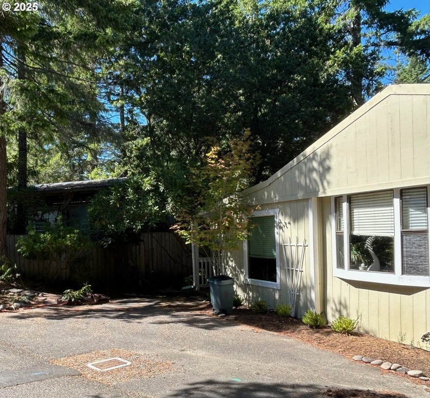 A charming Park model home that has wood siding and a ramada top - Beach Home for sale in Florence, Oregon on Beachhouse.com