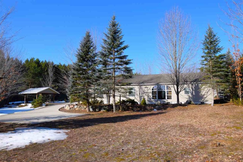 This welcoming home is nestled on 2.25-acres, blending privacy - Beach Home for sale in Alanson, Michigan on Beachhouse.com