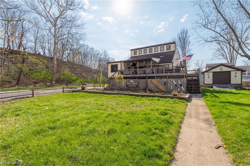 Enjoy riverfront living at its finest in this inviting 4-bedroom - Beach Home for sale in Vermilion, Ohio on Beachhouse.com