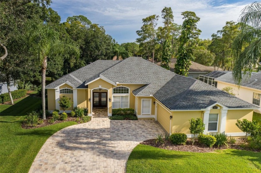 Enjoy serene pond views from this spectacular 3-bedroom plus - Beach Home for sale in Oldsmar, Florida on Beachhouse.com