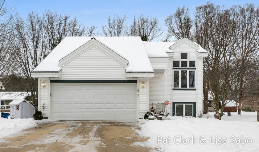 This meticulously maintained 4-bedroom, 2-bath home is ideally - Beach Home for sale in Spring Lake, Michigan on Beachhouse.com