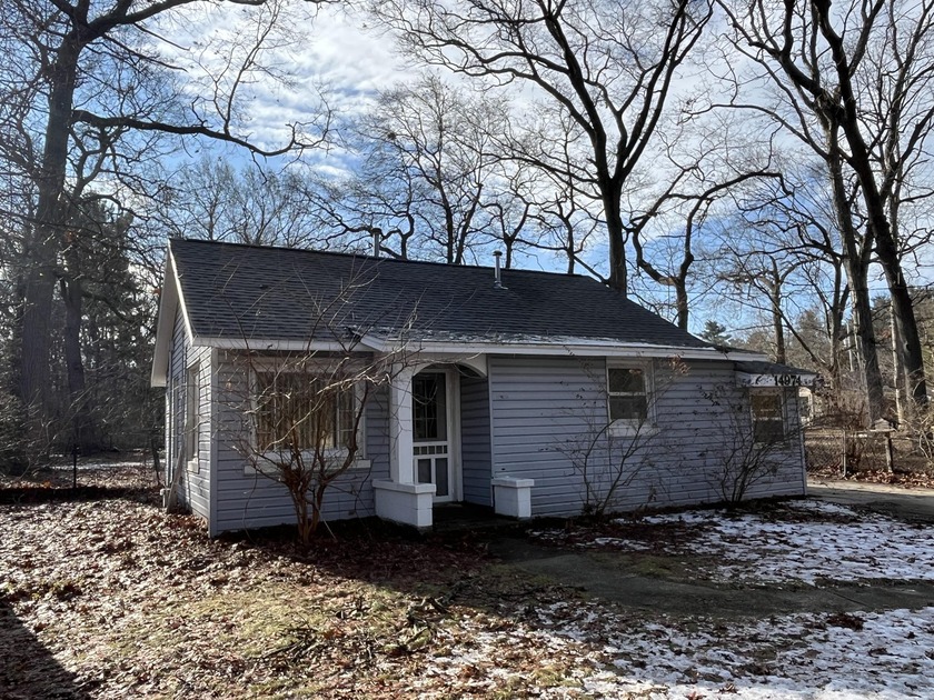 Enjoy the peaceful setting of this affordable home on a generous - Beach Home for sale in Grand Haven, Michigan on Beachhouse.com