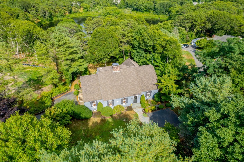 Beautifully ensconced by stately trees and tranquil pond, this - Beach Home for sale in Osterville, Massachusetts on Beachhouse.com