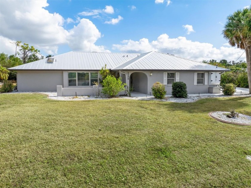 Welcome home! This remodeled and updated 3/3/2 pool home sits in - Beach Home for sale in Port Charlotte, Florida on Beachhouse.com