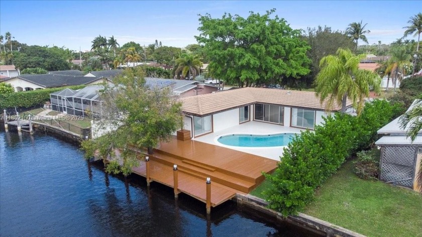 Stunning waterfront property featuring a spacious backyard, lush - Beach Home for sale in Oakland Park, Florida on Beachhouse.com