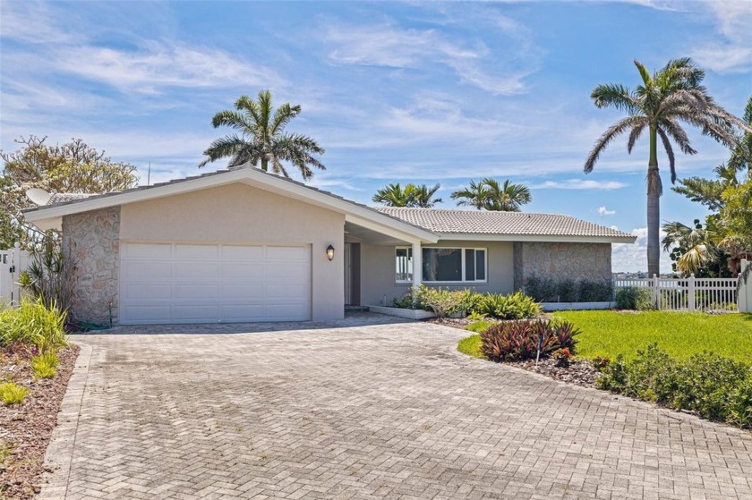 Beautifully landscaped with a long brick paver driveway, this - Beach Home for sale in Treasure Island, Florida on Beachhouse.com