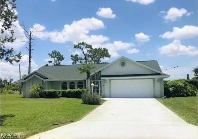 Spacious 4-bedroom, 2-bath single-family home situated on an - Beach Home for sale in Lehigh Acres, Florida on Beachhouse.com