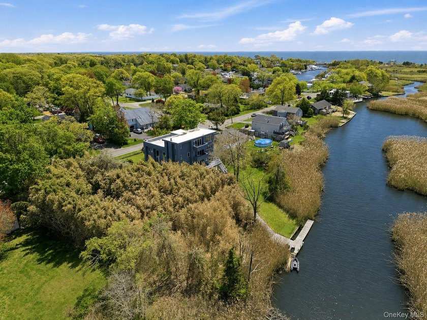Tucked within the highly sought-after waterfront community of - Beach Home for sale in East Patchogue, New York on Beachhouse.com