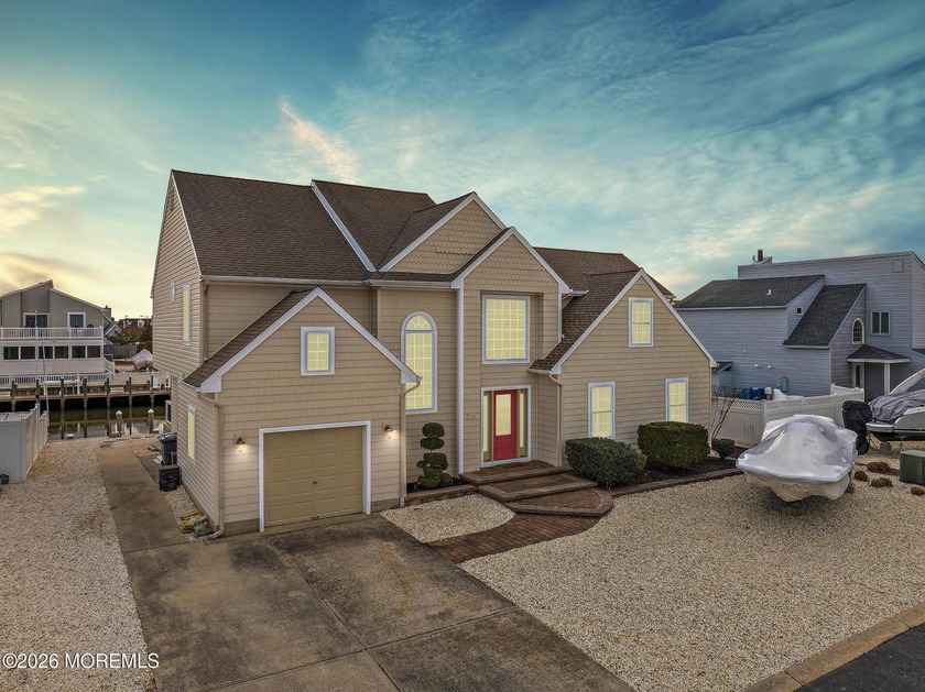 This immaculate custom waterfront home in The Coves of Village - Beach Home for sale in Manahawkin, New Jersey on Beachhouse.com