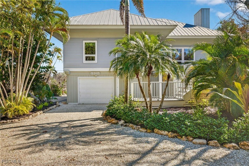 Surrounded by lush tropical landscaping, the home feels private - Beach Home for sale in Sanibel, Florida on Beachhouse.com