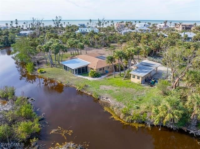 On an acre of land with expansive water views, this renovated - Beach Home for sale in Sanibel, Florida on Beachhouse.com