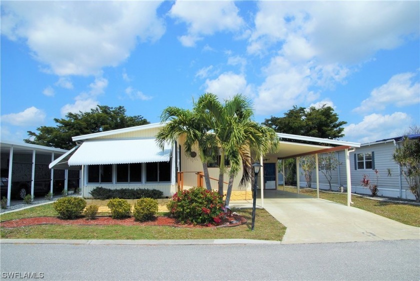 Move-in ready residence framed by swaying palms  adorned with - Beach Home for sale in North Fort Myers, Florida on Beachhouse.com