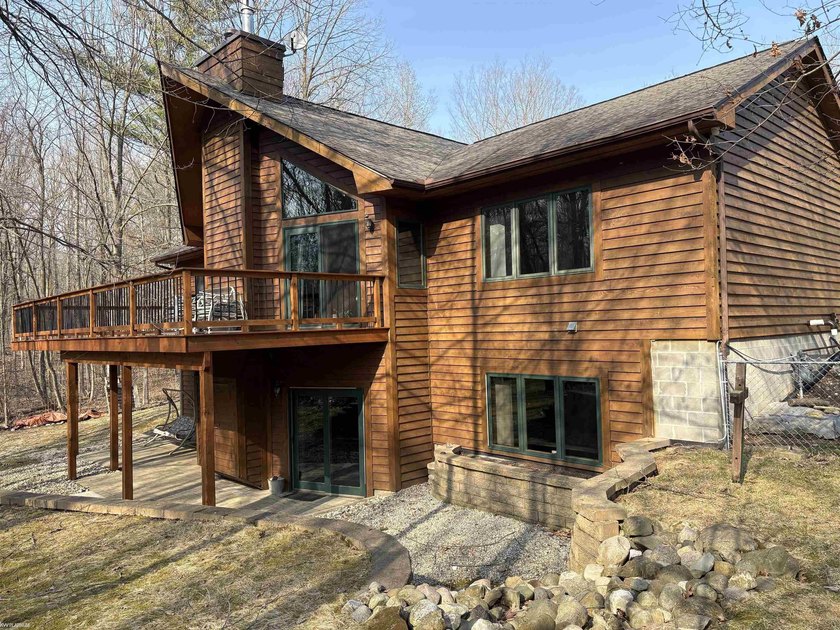 Set on over 7 wooded acres that backs state land, this custom - Beach Home for sale in Clyde, Michigan on Beachhouse.com