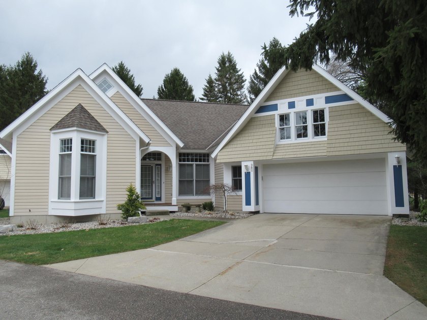 This stand alone home offers serenity  with a wooded view from - Beach Condo for sale in Holland, Michigan on Beachhouse.com
