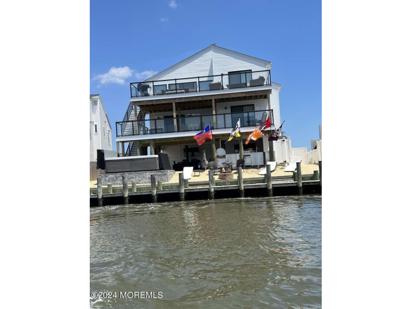 Located on Mill Creek, this beautiful 3-level home with an - Beach Home for sale in Manahawkin, New Jersey on Beachhouse.com