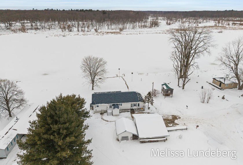 A rare Grand River retreat! 100' of deep water frontage, more - Beach Home for sale in Grand Haven, Michigan on Beachhouse.com