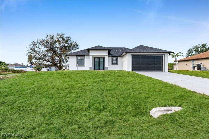 This stunning new construction offers a perfect blend of modern - Beach Home for sale in Lehigh Acres, Florida on Beachhouse.com