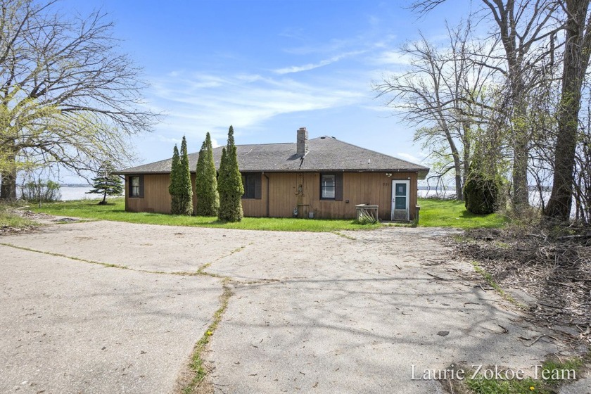 Located in a desirable neighborhood on Muskegon Lake, this home - Beach Home for sale in Muskegon, Michigan on Beachhouse.com