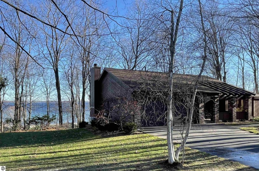 Nestled at the end of a quiet tree -lined cul-de-sac, and - Beach Home for sale in Traverse City, Michigan on Beachhouse.com
