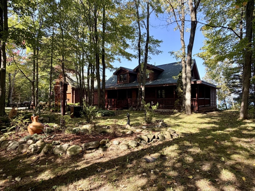 This beautifully crafted log home offers 120 feet of frontage on - Beach Home for sale in Cheboygan, Michigan on Beachhouse.com