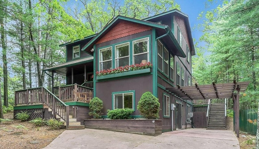 Nestled among the trees, this beautifully updated three-story - Beach Home for sale in Pentwater, Michigan on Beachhouse.com