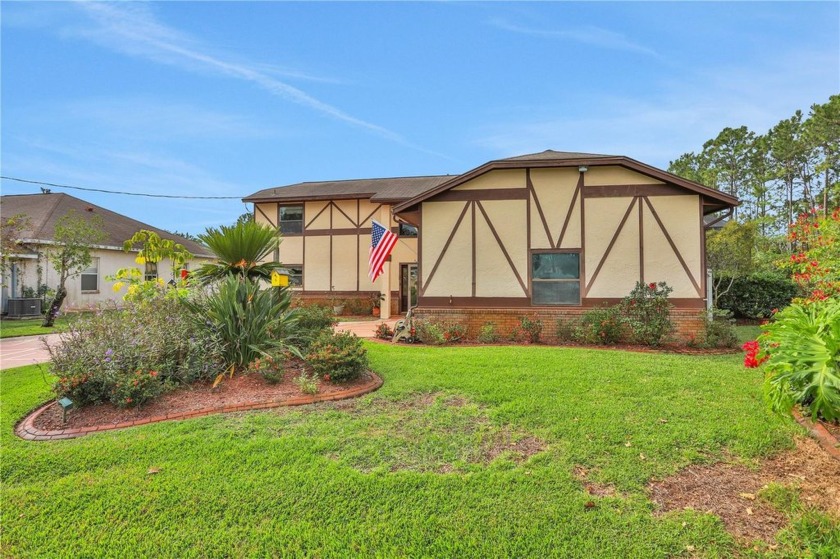 Discover this stunning custom-built Tudor-style home tucked away - Beach Home for sale in Palm Coast, Florida on Beachhouse.com