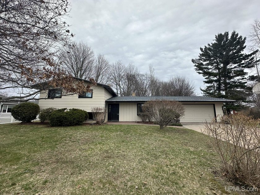 Welcome to this spacious and character-filled tri-level home in - Beach Home for sale in Escanaba, Michigan on Beachhouse.com