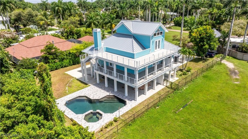 LUXURIOUS 5-BEDROOM HOME WITH LAGOON-STYLE POOL AND RIVER VIEWS - Beach Home for sale in Fort Myers, Florida on Beachhouse.com