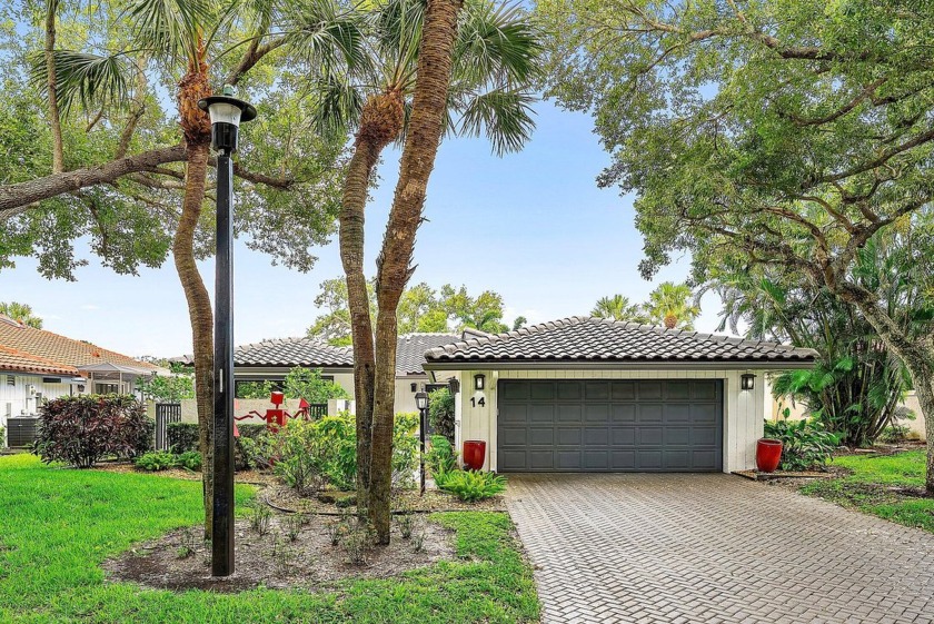 Nestled in The Oaks at Hunters Run Country Club, this - Beach Home for sale in Boynton Beach, Florida on Beachhouse.com