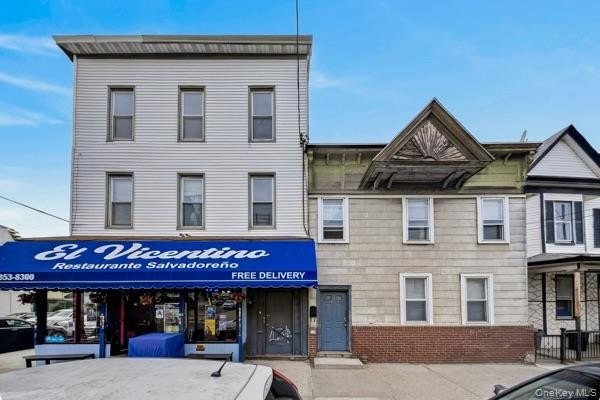 This well-located mixed-use building features a busy - Beach Lot for sale in College Point, New York on Beachhouse.com