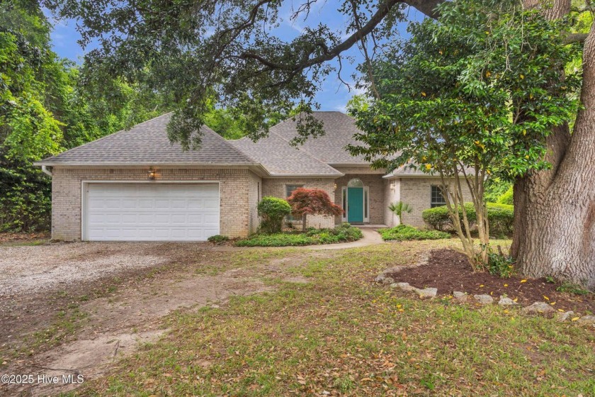 Tucked away on a spacious, pie-shaped lot, this hidden gem on - Beach Home for sale in Hampstead, North Carolina on Beachhouse.com
