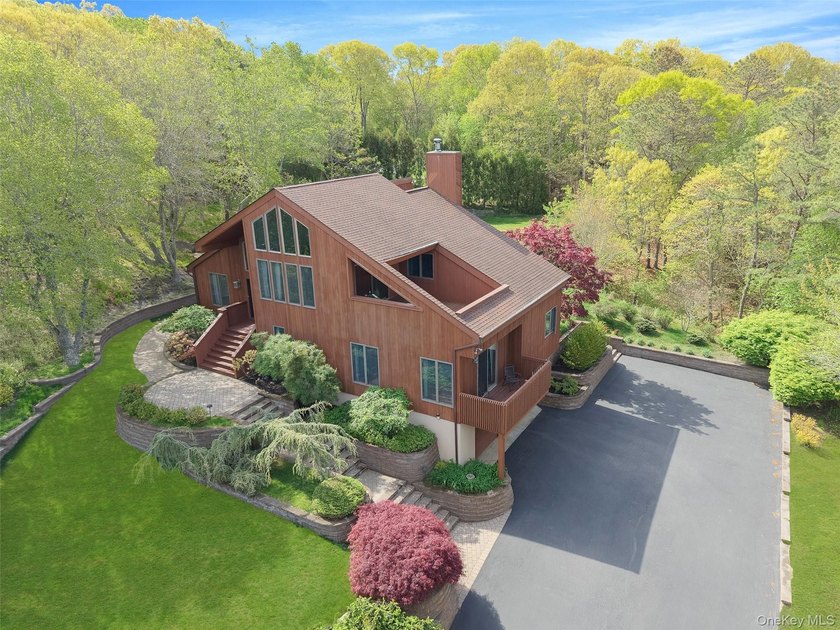 Set within the quiet Rolling Woods neighborhood on a shy acre at - Beach Home for sale in Riverhead, New York on Beachhouse.com