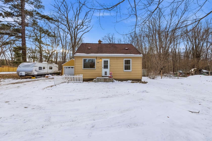 Nestled on nearly a half-acre, this updated bungalow is ready - Beach Home for sale in Muskegon, Michigan on Beachhouse.com