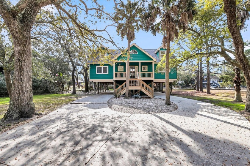 Nestled on a quiet, wooded TIDAL creek lot is this classic Folly - Beach Home for sale in Folly Beach, South Carolina on Beachhouse.com