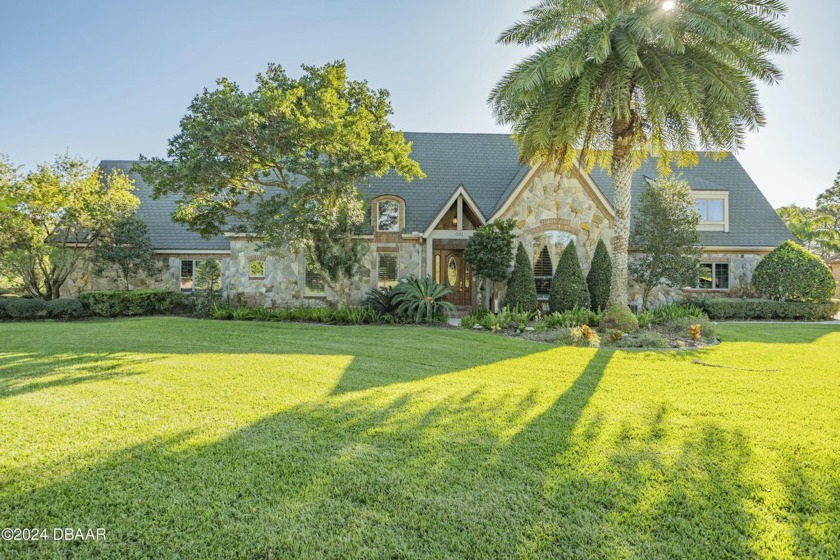 Nestled on a beautifully landscaped 0.65-acre lot, this - Beach Home for sale in Ormond Beach, Florida on Beachhouse.com