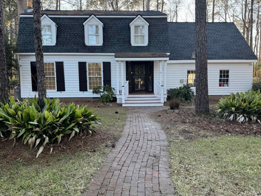 Welcome to this inviting two-story home situated on nearly an - Beach Home for sale in Pawleys Island, South Carolina on Beachhouse.com