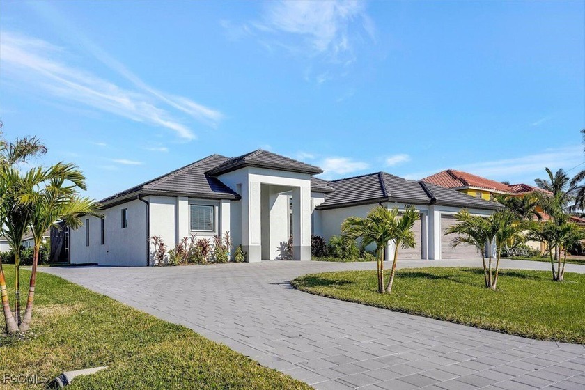 Extraordinary New Build on a Rare TRIPLE LOT! This immaculate - Beach Home for sale in Cape Coral, Florida on Beachhouse.com