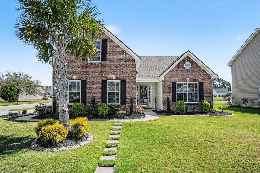 Situated on a corner lot with a beautiful view of the lake, this - Beach Home for sale in Murrells Inlet, South Carolina on Beachhouse.com