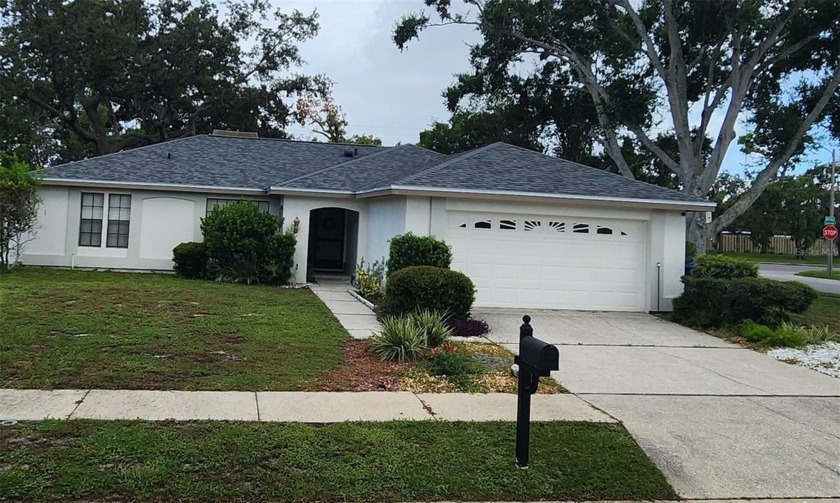 Discover this charming home located on a quiet corner lot in a - Beach Home for sale in Holiday, Florida on Beachhouse.com
