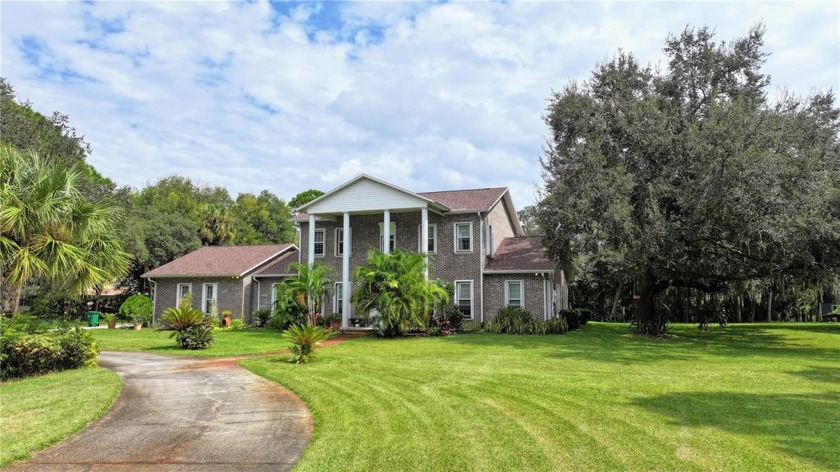 This Brick Colonial-style home is nestled on 2.15 private wooded - Beach Home for sale in Titusville, Florida on Beachhouse.com