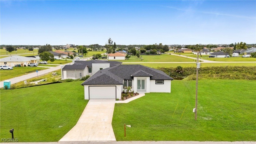 This stunning brand-new construction sits on a rare triple - Beach Home for sale in Cape Coral, Florida on Beachhouse.com