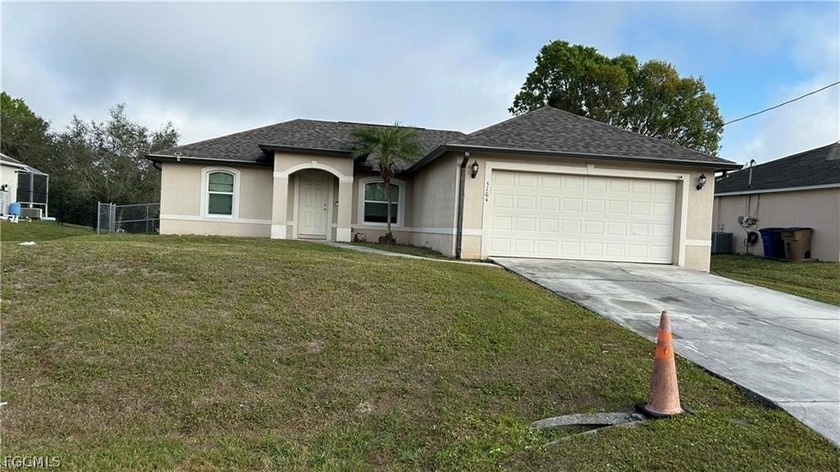 Great 3-bedroom, 2-bathroom home with a 2-car garage, nestled on - Beach Home for sale in Lehigh Acres, Florida on Beachhouse.com