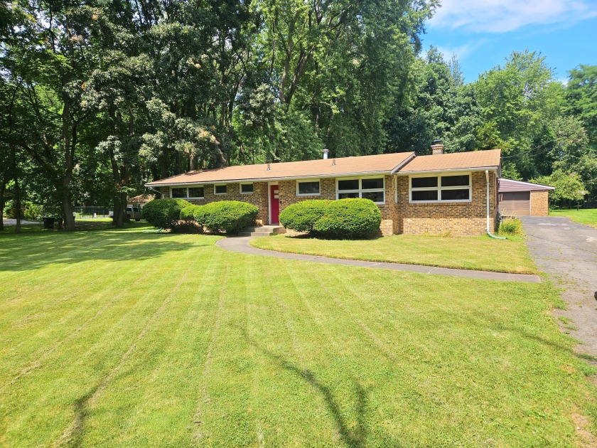 This charming brick ranch, nestled on a beautifully wooded - Beach Home for sale in Portage, Indiana on Beachhouse.com